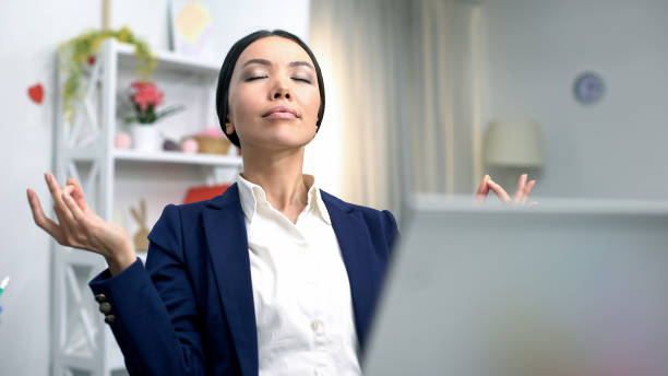 istock Young business lady meditating front laptop reducing stress, relaxing technique 1162336973