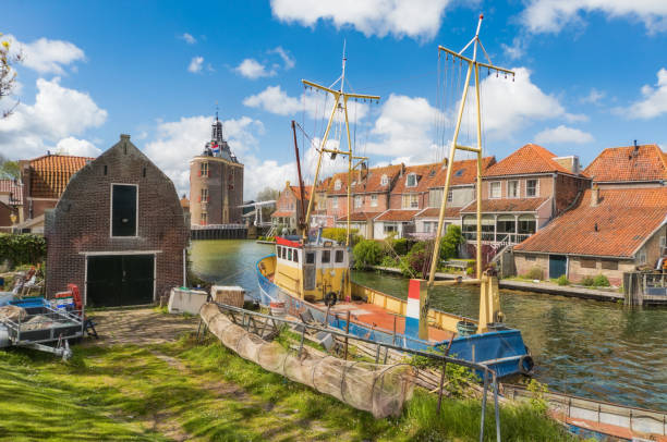 Fishing boat in Enkhuizen in the Netherlands with the historic city gate (Drommedaris) in the background. Fishing boat in Enkhuizen in the Netherlands with the historic city gate (Drommedaris) in the background. enkhuizen stock pictures, royalty-free photos & images
