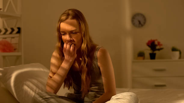 istock Anxious young woman sitting in bedroom thinking of problem, suffering stress 1162338185