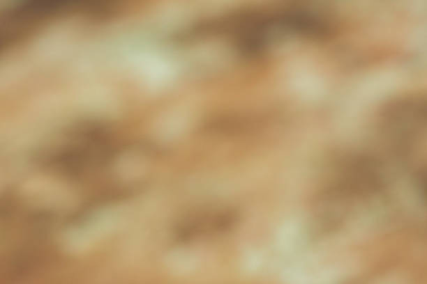A rustic Autumnal coloured bokeh background.  The look is mottled or vintage.  The colours are symbolic of wealth, love, warmth, Autumn.