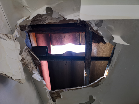 One tile has slipped from a roof.  The rain has caused the ceiling below to collapse.  A DIY project is needed to repair the problem.  Home insurance may cover the costs.