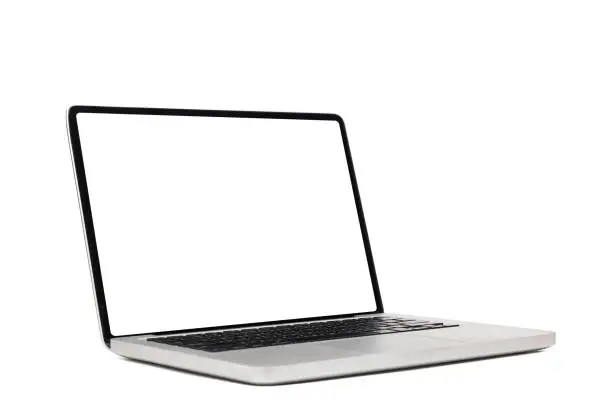 Photo of laptop computer mock up with empty blank white screen isolated on white background with clipping path, side view. modern computer technology concept