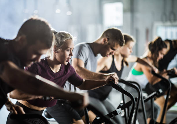 istock gym training on stationary bikes! 1162340572