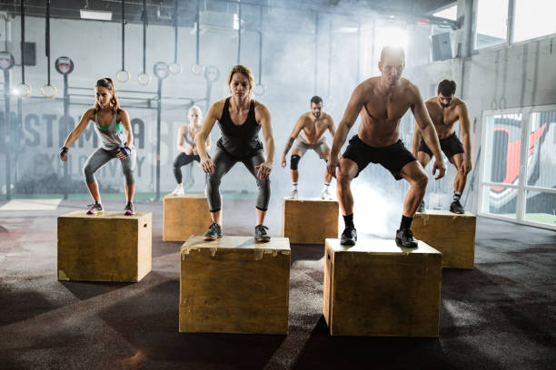 istock Athletic people exercising jumps on crates during gym training in a gym. 1162341553