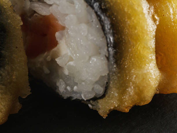 istock sushi rolls on gray stone slate on wood background 1162343520