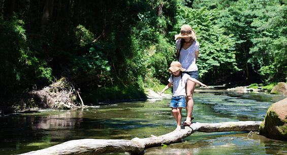 Mother and child playing in a mountain stream