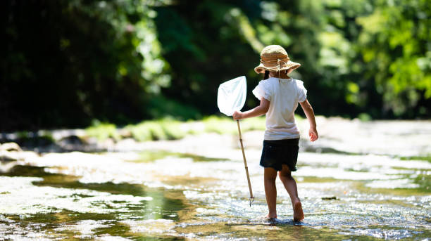 Child playing in a mountain stream
