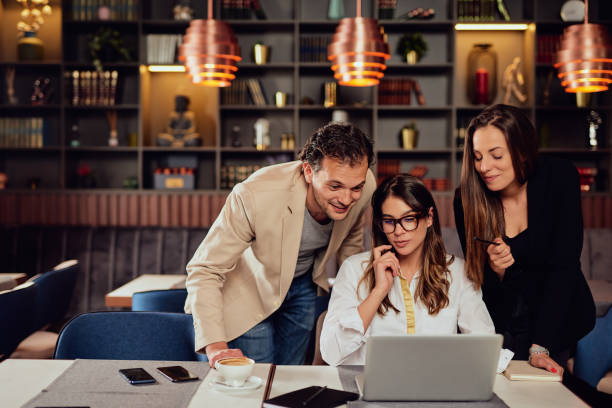 istock Colleagues looking at laptop and trying to solve a problem. Cafe interior. 1162346301
