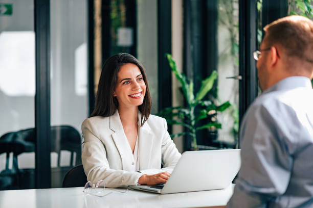 positive female financial advisor on a meeting with a client. - 3369 imagens e fotografias de stock