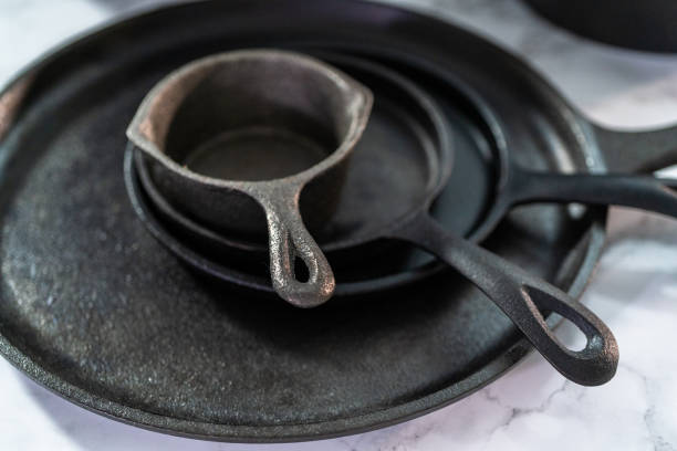 istock Variety of cast iron frying pans on a marble background. 1162347607