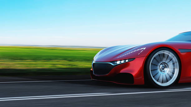 istock red car driving on a road 1162347974