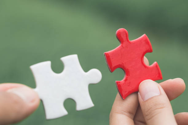 istock Hand connect white and red jigsaw parts with word problem & solution.   symbol of association and connection. business strategy. Teamwork concept. 1162348834