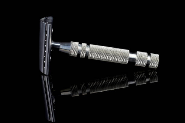 istock classic stainless steel razor. Cut slant. Black background with reflection. 1162350508