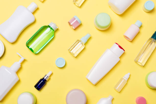 istock Top view of different cosmetic bottles and container for cosmetics on yellow background. Flat lay composition with copy space 1162351773
