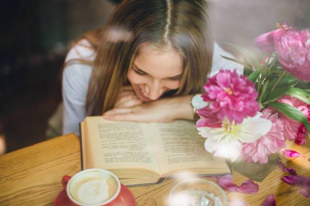 istock Cute girl enjoying coffee and a book 1162351865