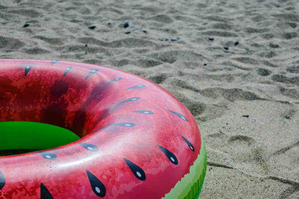 istock Watermelon swimming ring on a beach 1162351918