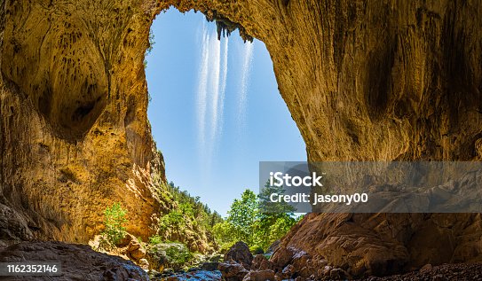 istock Inside Tonto Natural Bridge Panorama with a Waterfall 1162352146