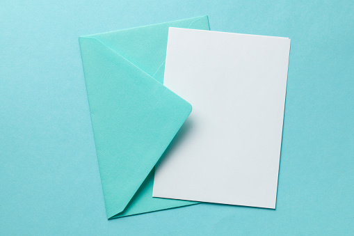 Green envelope and blank letter on green background. Template with place for text on postcard. mock-up.
