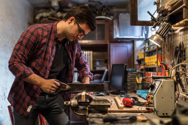 istock Man cutting wooden board in workshop 1162355470