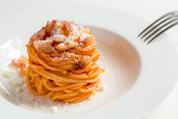 Amatriciana - Italian pasta Homemade Amatriciana - Italian pasta based on guanciale (cured pork cheek), pecorino cheese, tomato, white wine,  olive oil. Cucina romana tradizionale. Original recipe fixed by Comune di Amatrice. rieti stock pictures, royalty-free photos & images