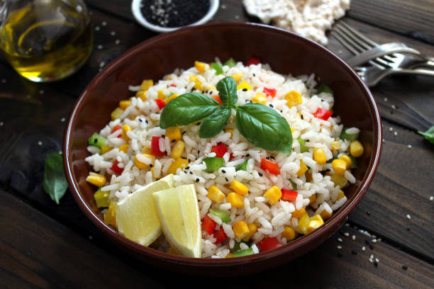 istock Rice salad with vegetables and sesame on wooden background. 1162356757