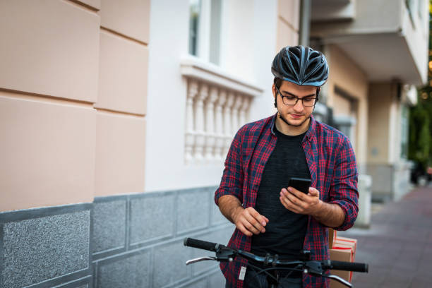 istock Bike delivery boy using smartphone in the city 1162357762