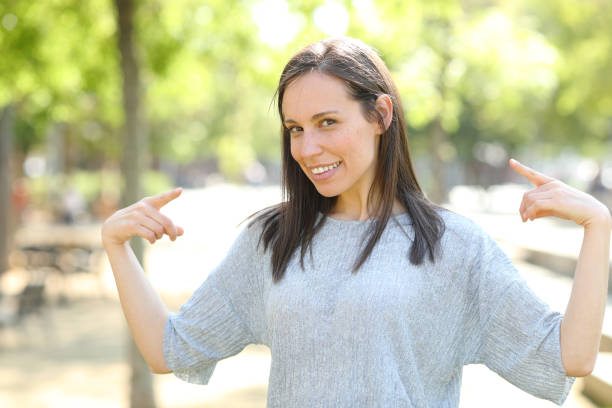 istock Proud woman pointing herself in a park 1162357786