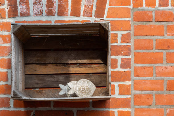Decoration with fish and wooden box on a stone wall