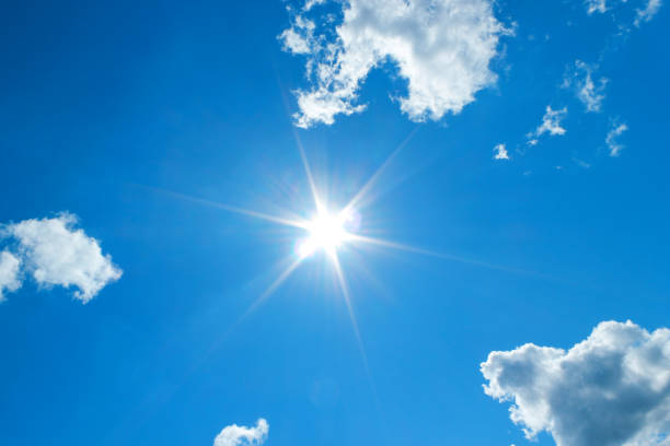 istock Sunshine in blue sky with white clouds 1162358710