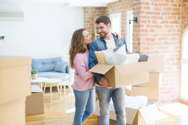 istock Young beautiful couple moving to a new home 1162360210