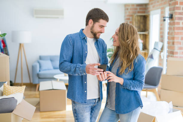 istock Young beautiful couple moving to a new home 1162360419
