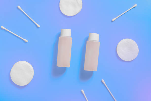 istock Cosmetic bottles, ear sticks and cotton swabs on blue violet background. Space for text, 1162360869