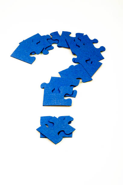 Blue puzzle in the shape of a question mark on a white isolated background