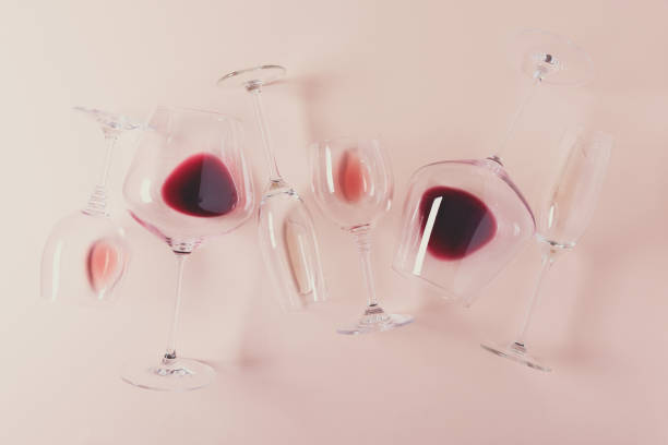 istock Assorted wineglasses with red, rose and white wine lying on pink background. Wine degustation concept. Flat lay. Top view. Copy space. Toned 1162360969