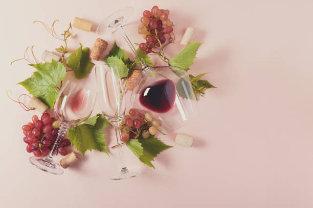 istock Assorted wineglasses with red, rose and white wine, grape, leaves and cork lying on pink background. Wine degustation concept. Flat lay. Top view. Copy space. Toned 1162361124