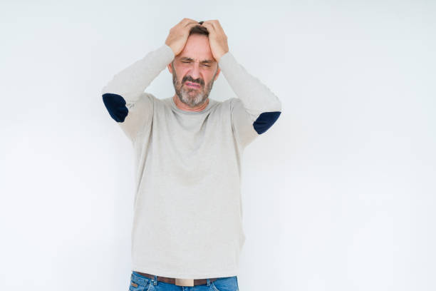 istock Elegant senior man over isolated background suffering from headache desperate and stressed because pain and migraine. Hands on head. 1162361176