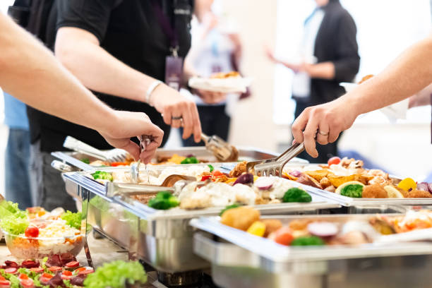 istock Hands picking up food from buffet catering table at the party. 1162361264