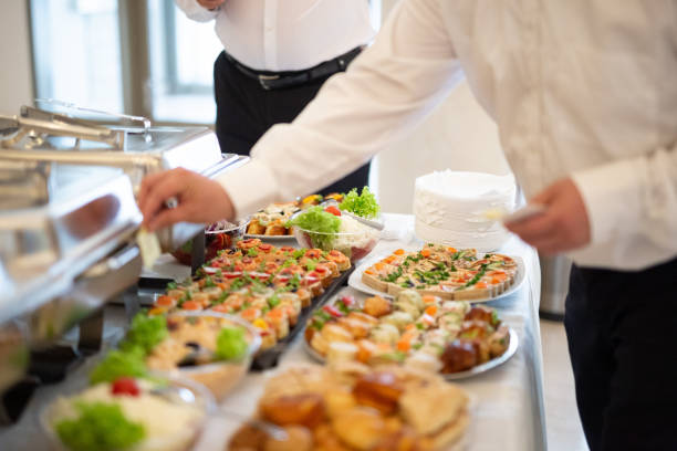 istock Waiters serving buffet canapes on table. Food and celebration concept. 1162362015