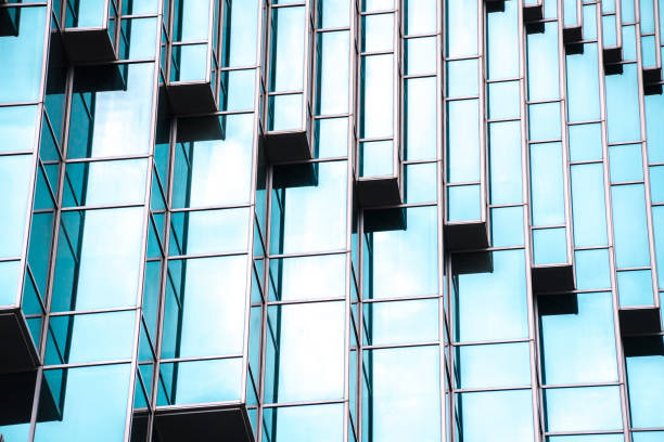 istock underside panoramic and perspective view to steel blue glass high rise building skyscrapers, business concept of successful industrial architecture 1162362403