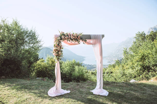 Beautiful wedding arch with flowers Beautiful wedding arch with flowers on the background of the Boko-Kotor Bay in Montenegro. Preparation for a wedding event. Arc stock pictures, royalty-free photos & images