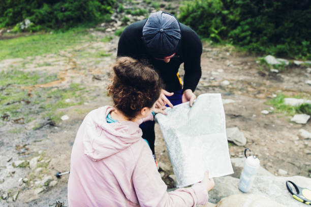 istock Woman and man planning trip with map in the mountains 1162362956