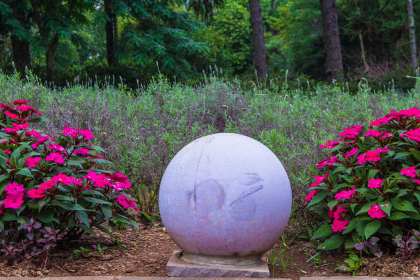 Pink Impatiens and a concrete sphere