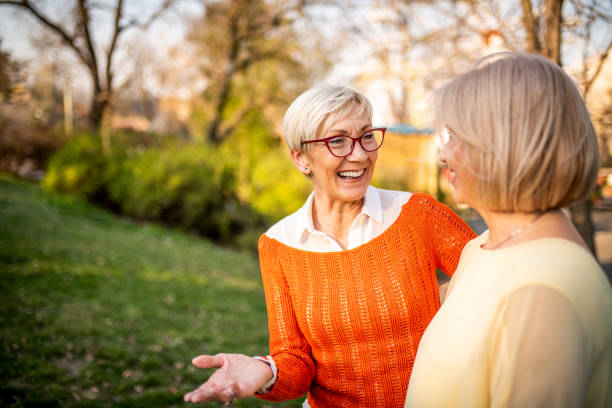 istock Two senior women laughing at the park 1162370857
