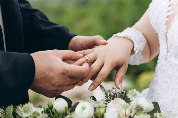 istock The groom puts the ring on the bride 1162377508