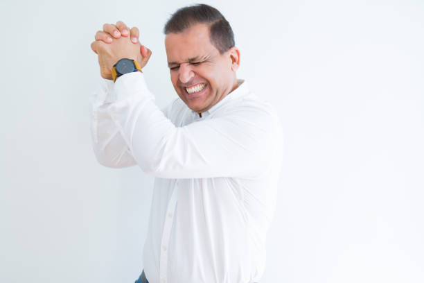 istock Middle age man celebrating and screaming happy for succesful win 1162382439