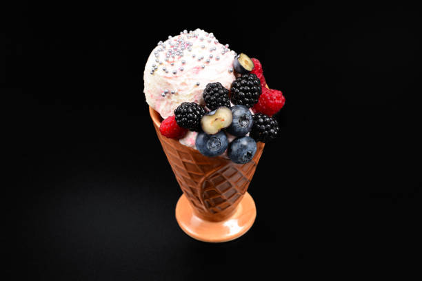 istock Ice cream with blueberries, blackberries and raspberries on a black background.  Copy space. 1162384184