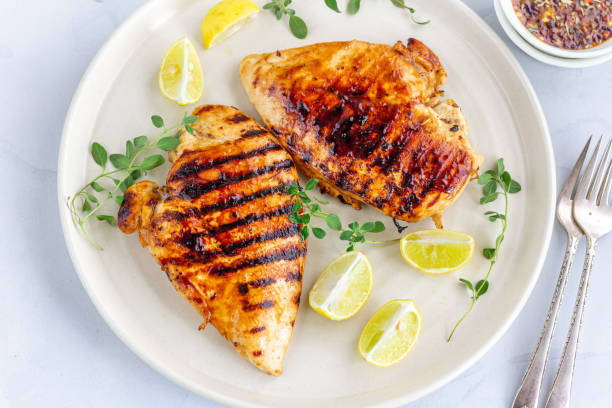 istock Marinated grilled healthy chicken breasts in a White Plate 1162385587