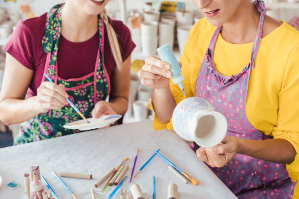 istock Two women painting own ceramic tableware in DIY workshop 1162386476