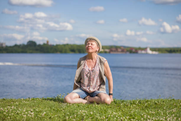 istock An elderly woman meditates outdoors. 1162386571