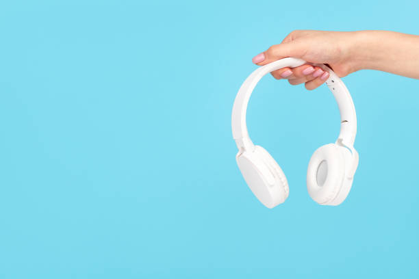 istock Girl showing modern wireless headphones 1162388053